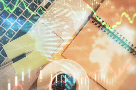 Stock market graph and top view computer on the table background. Double exposure. Concept of financial education.の写真素材