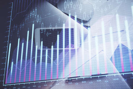 Multi exposure of forex graph hologram over desktop with phone. Top view. Mobile trade platform...