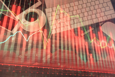 Double exposure of forex chart hologram over desktop with phone. Top view. Mobile trade platform...