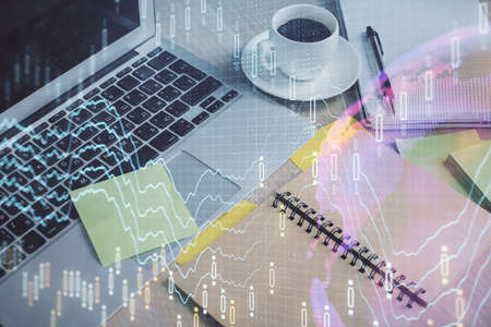 Multi exposure of forex graph drawing and desktop with coffee and items on table background. Concept...