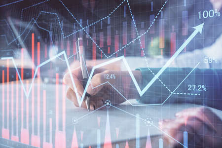 Double exposure of forex chart drawing over people taking notes background. Concept of financial...