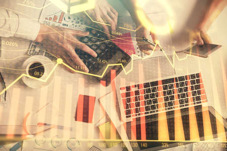 Double exposure of man and woman working together and financial chart hologram drawing. market...