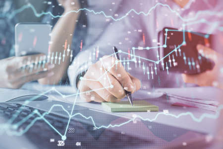 Double exposure of man and woman working together and financial graph hologram. Business concept....
