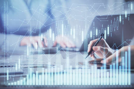 Multi exposure of woman hands typing on computer and financial chart hologram drawing. Stock market...