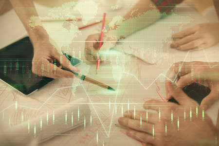 Double exposure of forex graph drawing and man and woman working together holding and using a mobile...