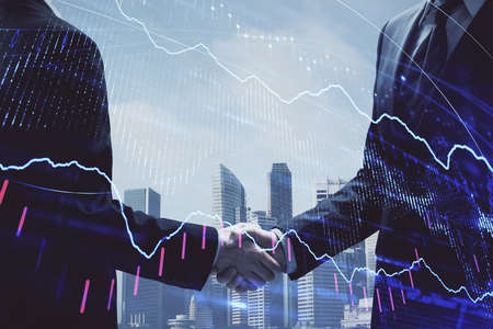 Double exposure of forex graph hologram and handshake of two men. Stock market concept.