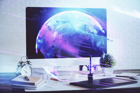 Computer on desktop in office with technology theme hologram. Double exposure. Tech concept.の写真素材