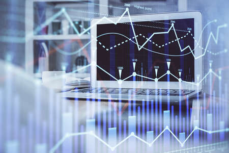 Stock market graph and table with computer background. Multi exposure. Concept of financial...