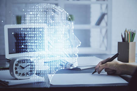 Multi exposure of writing hand on background with brain hologram. Concept of learning.