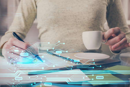 Double exposure of writing hands on background with data solution hologram on front. Technology...