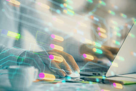 Businessman with computer background with technology theme hologram. Concept of hightech. Multi...
