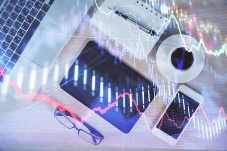 Multi exposure of forex graph hologram over desktop with phone. Top view. Mobile trade platform...