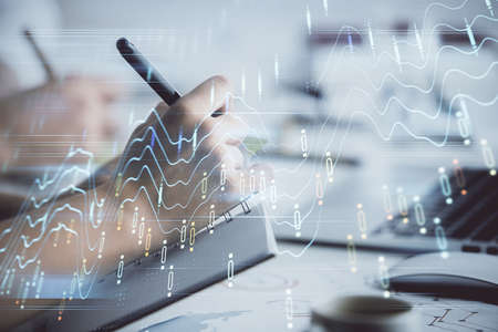Double exposure of forex graph drawing over people taking notes background. Concept of financial analysisの写真素材