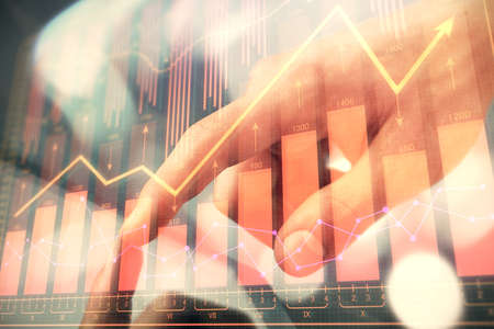 Multi exposure of mans hands holding and using a phone and financial chart drawing. Market analysis...