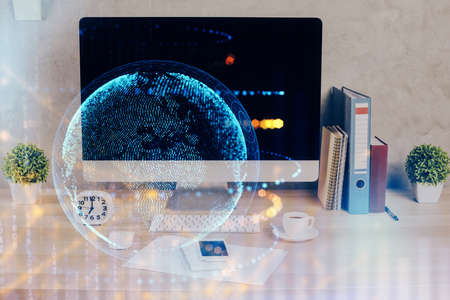 Double exposure of desktop with computer and world map hologram. International data network concept.の写真素材