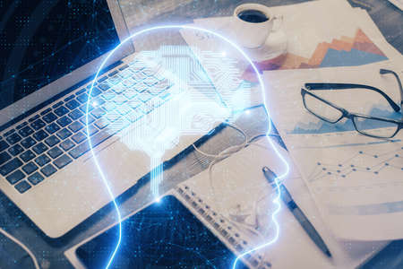 Double exposure of desktop with computer and brain drawing hologram. Artificial intelligence...