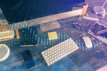 Double exposure of forex graph and work space with computer. Concept of international online...