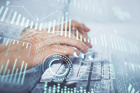Technology theme hologram with man working on computer on background. High tech concept. Multi...