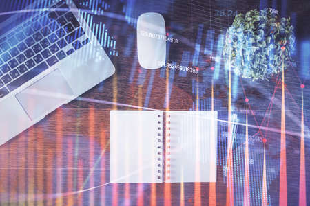 Stock market graph and top view computer on the table background. Double exposure. Concept of...