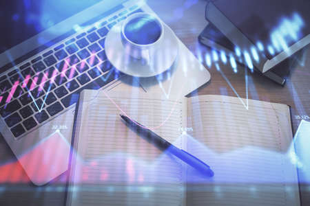 Stock market graph and top view computer on the table background. Multi exposure. Concept of...