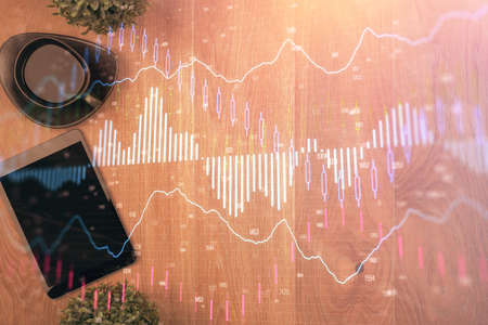 Multi exposure of financial chart hologram over desktop with phone. Top view. Mobile trade platform...