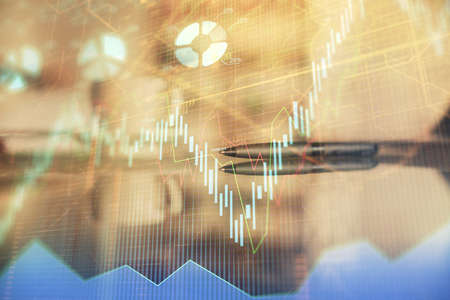Double exposure of forex chart over coffee cup background in office. Concept of financial analysis and success.の写真素材