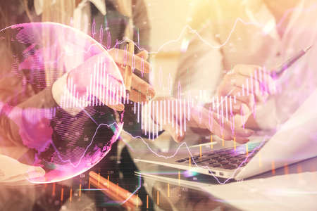 Double exposure of man and woman working together and forex chart hologram. Business concept....