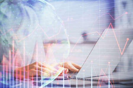 Double exposure of woman hands working on computer and forex graph hologram drawing. Financial analysis concept.の写真素材