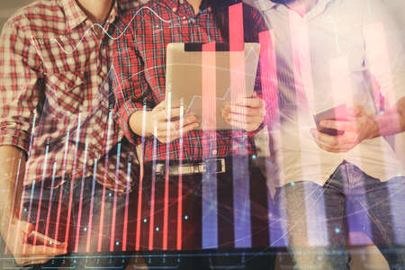 Double exposure of forex graph drawing and man and woman working together holding and using a mobile...