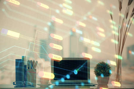 Double exposure of table with computer on background and data theme hologram. Data technology concept.の写真素材