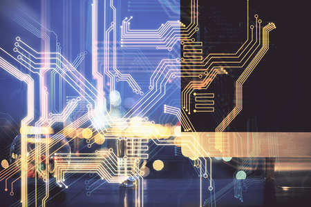 Computer on desktop in office with technology theme hologram. Double exposure. Tech concept.の写真素材