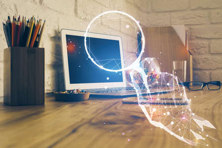 Desktop computer background in office and start up theme hologram drawing. Double exposure. Startup concept.の写真素材
