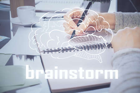 Start up creative drawing over close up hands in notepad background. Concept of brainstorming. Double exposureの写真素材