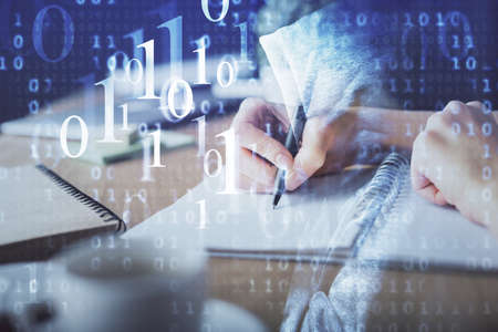 Double exposure of hands making notes background with technology and digital coding huds. Data learning concept.の写真素材