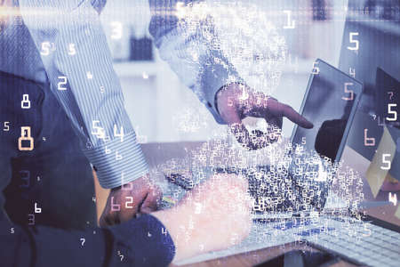 Technology theme hologram with man working on computer on background. High tech concept. Multi...