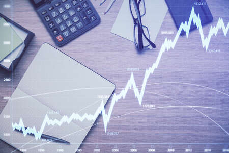 Double exposure of forex graph drawing and work table top veiw. Concept of financial analysis.