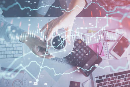 Double exposure of man and woman working together and financial chart hologram drawing. market...