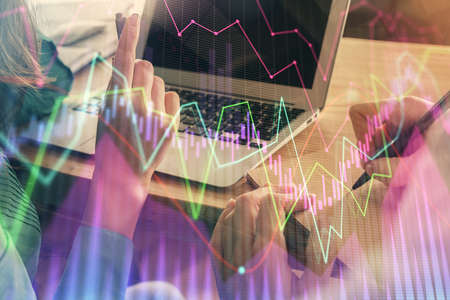 Double exposure of man and woman working together and forex chart hologram. Business concept....
