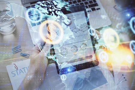 Double exposure of mans hands holding and using a digital device and forex graph drawing. Financial...
