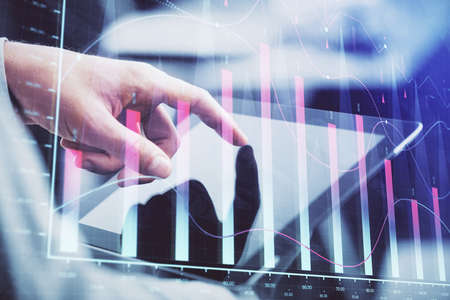 Multi exposure of mans hands holding and using a phone and financial chart drawing. Market analysis...