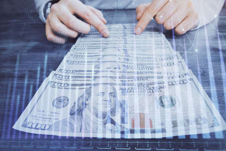 Multi exposure of forex graph drawing hologram and USA dollars bills and man hands. Technical Analysis concept.の写真素材