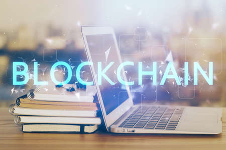 Double exposure of blockchain theme hologram and table with computer background. Concept of bitcoin...