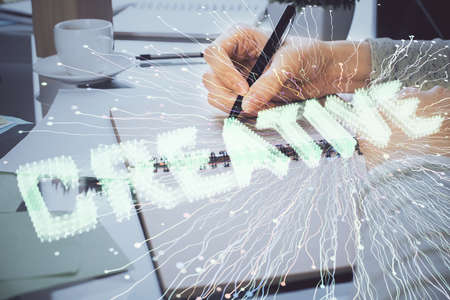 Start up creative drawing over close up hands in notepad background. Concept of brainstorming....
