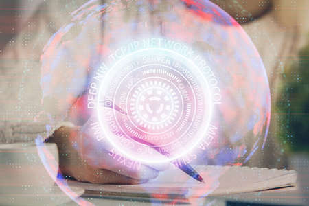 Tech theme hologram over womans hands taking notes background. Concept of hightech. Double exposureの写真素材
