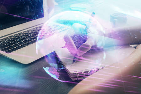 Tech theme hologram over womans hands taking notes background. Concept of hightech. Double exposureの写真素材