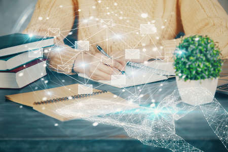 E-mail abstract envelop drawing over hands taking notes background. Concept of electronic mail....