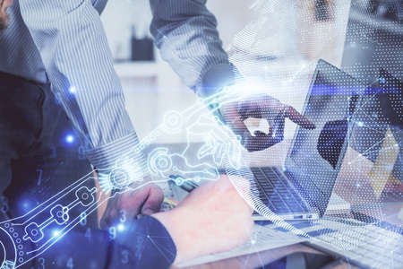 Technology theme hologram with man working on computer on background. High tech concept. Multi...