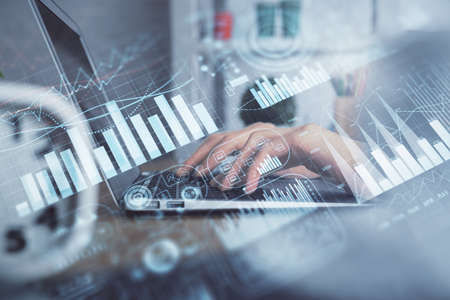 Double exposure of woman hands typing on computer and forex chart hologram drawing. Stock market...