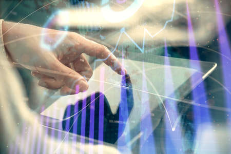 Multi exposure of mans hands holding and using a phone and financial chart drawing. Market analysis...
