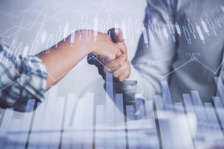 Double exposure of forex graph hologram and handshake of two men. Stock market concept.